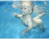 Image of a small baby underwater with eyes open