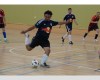 Image of man kicking a ball in indoor soccer