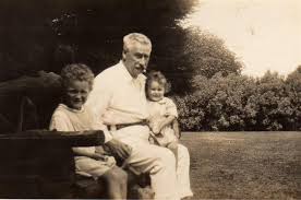 Lt Col James Tedder sitting on a bench with two grandchildren on his Wamberal farm shortly before his death.