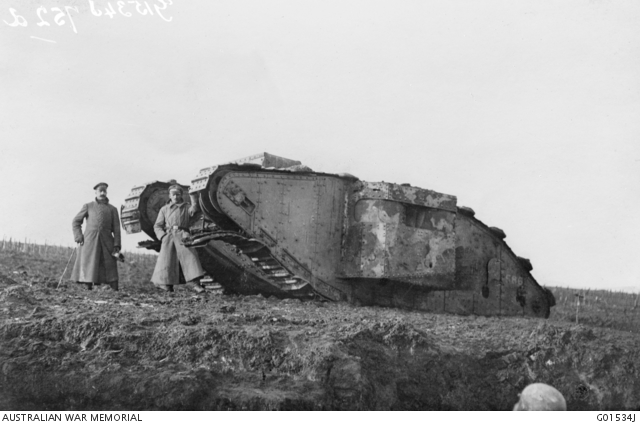 Two gErman soldiers beside a captured British tank at Bullecourt
